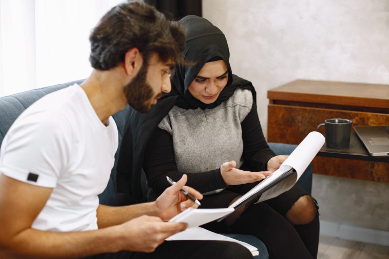 Students reviewing personal budgeting worksheets during program session